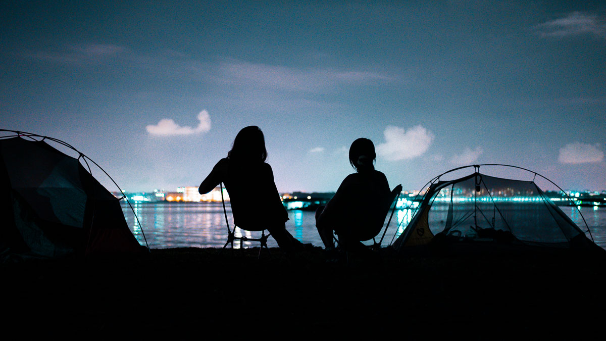 People sitting by the tents - Pulau Ubin Camping