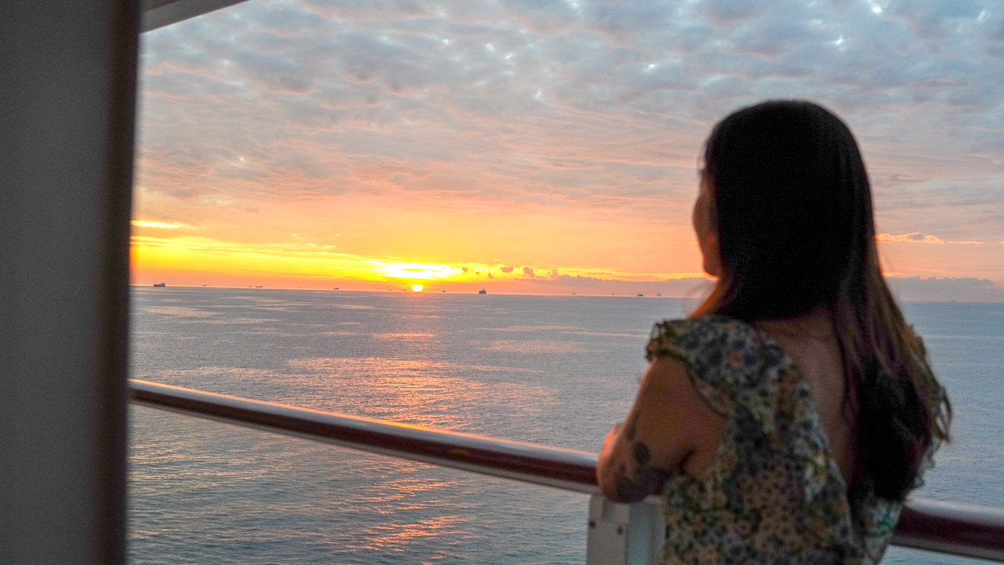 Girl Watching Sunrise at Cruise Balcony