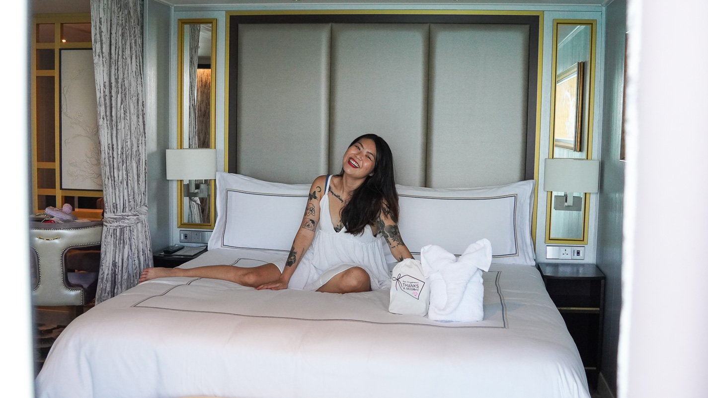 Girl on king size bed in Palace Suite - Dream Cruise Palace