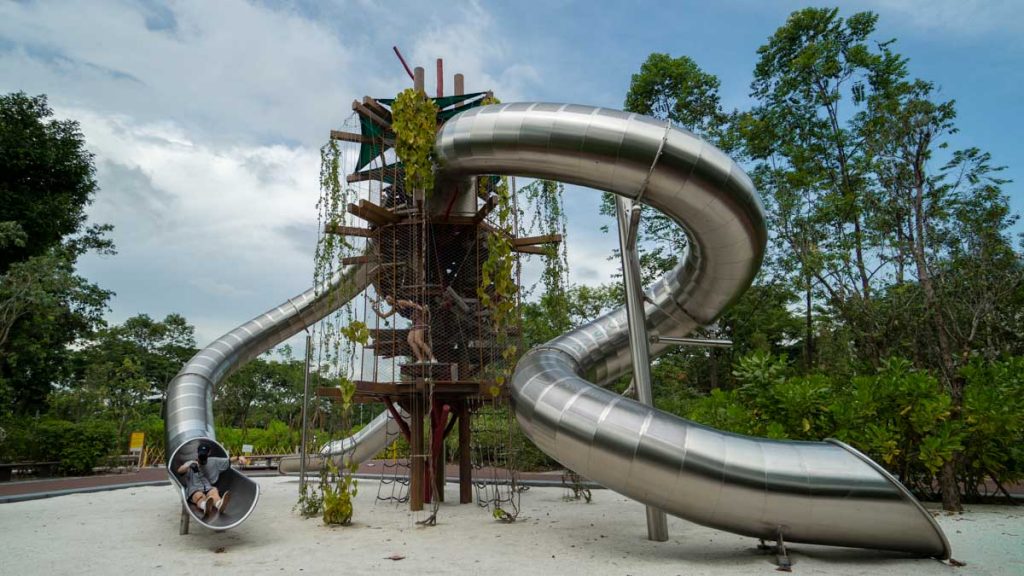 Boy Sliding down Giant Slide at Forest Ramble — Nature-themed playground
