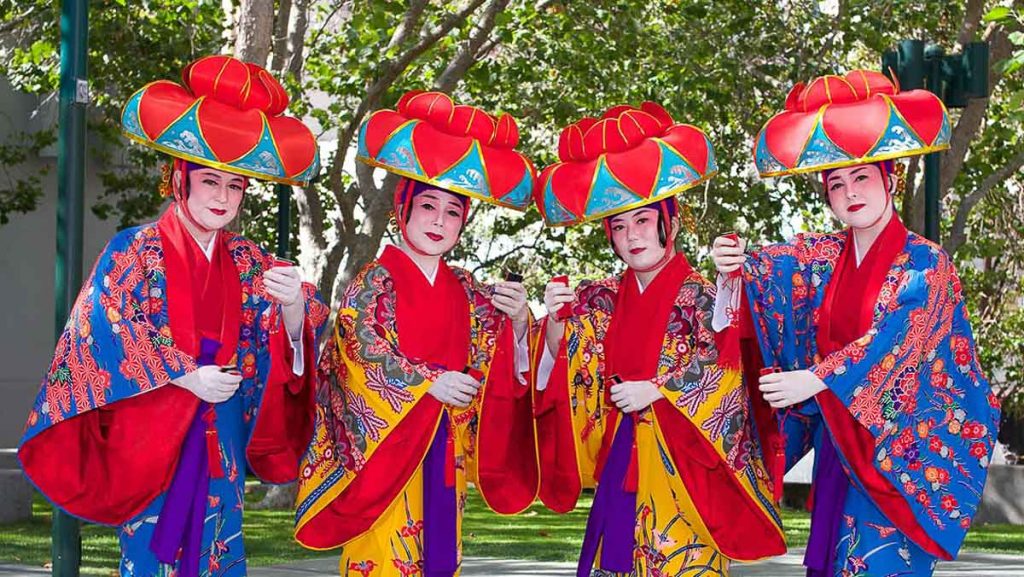 Okinawan cultural performers wearing traditional ryuso costumes - cultures explained Okinawa different from Japan