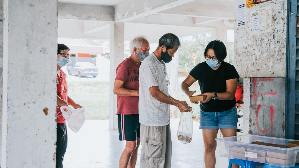 Volunteer distributing food to elderly — YEP-GO