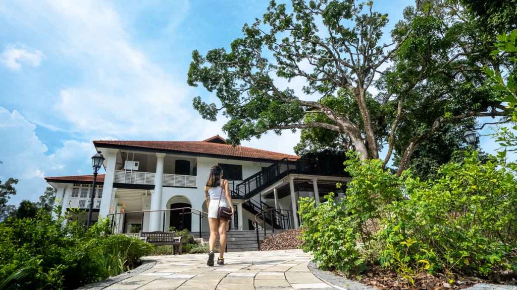 Girl standing in front of monochrome colonial house — Singapore Botanic Gardens Gallop Extension