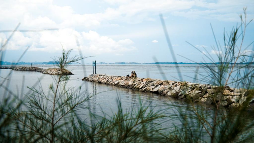 People sitting by the Breakwater – Kusu Island