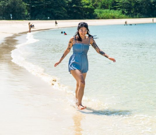 Girl frolicking in the waters Lazarus Beach - St. John's Island and Lazarus Island