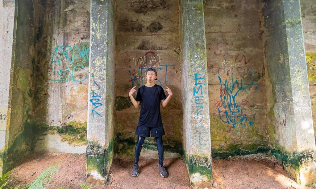 Boy at Graffiti Pillars Near Abandoned Flyover Rail Corridor