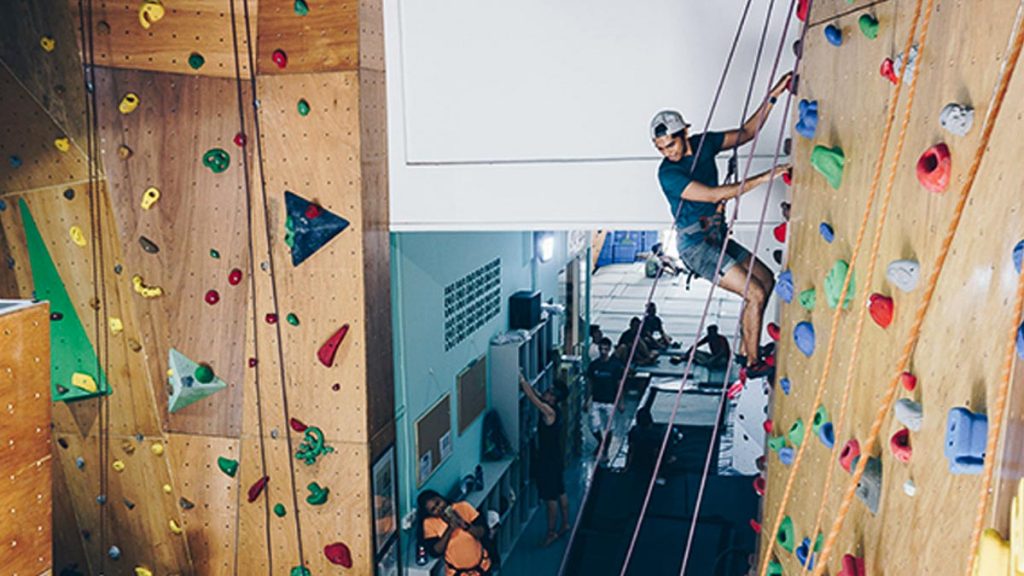 Man Climbing Rock Wall at Kinetics Climbing — Olympic Sport to try in Singapore