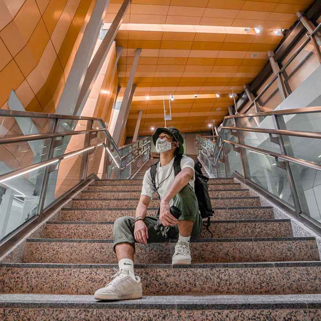 Boy Sitting on Woodlands Stairs Singapore MRT Station