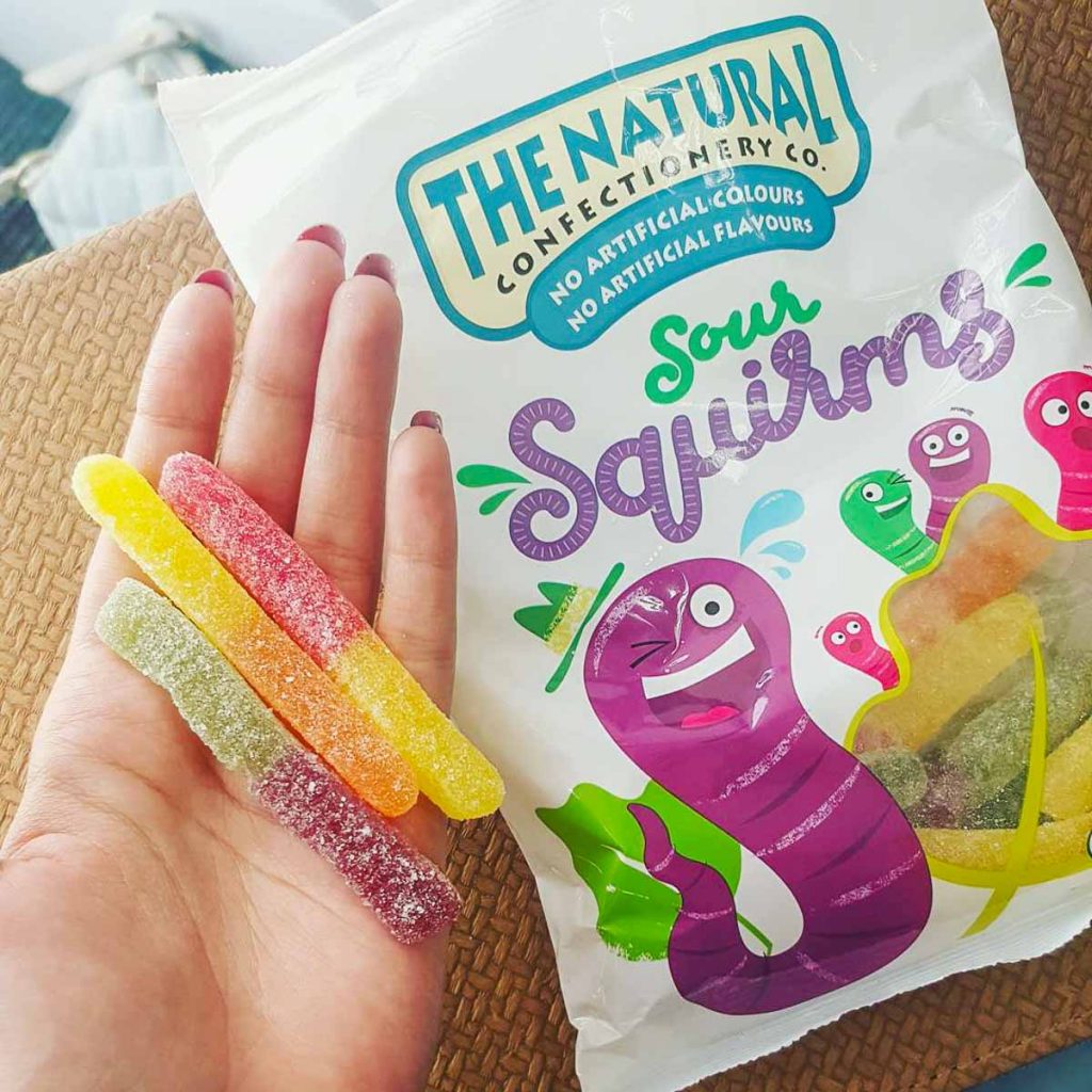 Colourful Sour Squirms Candy on Hand
