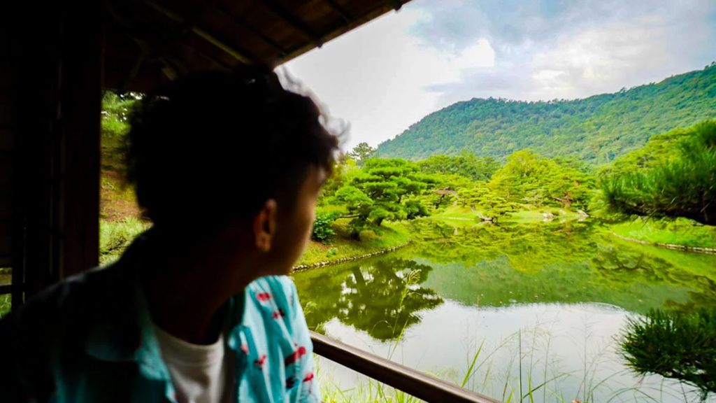 Man Looking at Scenic Garden View