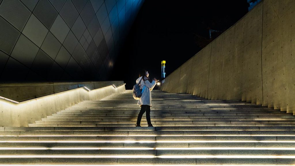 Girl Standing on Dongdaemun Design Plaza Stairs Singapore South Korea VTL Itinerary