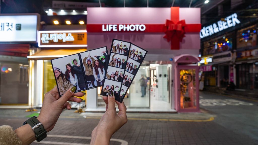 Hand Holding Neoprints at Hongdae Photo Booth Singapore South Korea VTL Itinerary