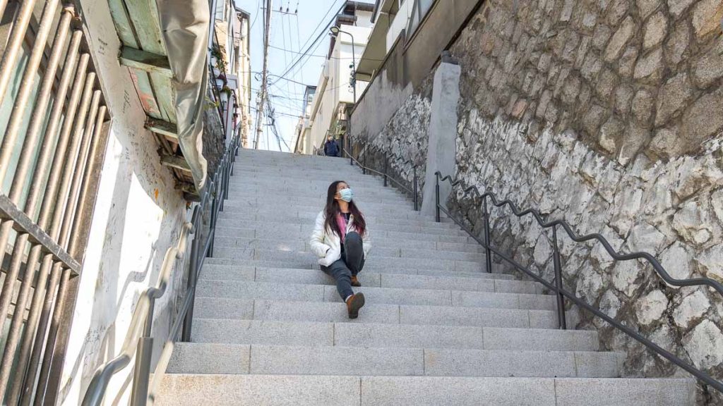 Girl Sitting on Flower Staircase Ihwa Mural Village Singapore South Korea VTL Itinerary