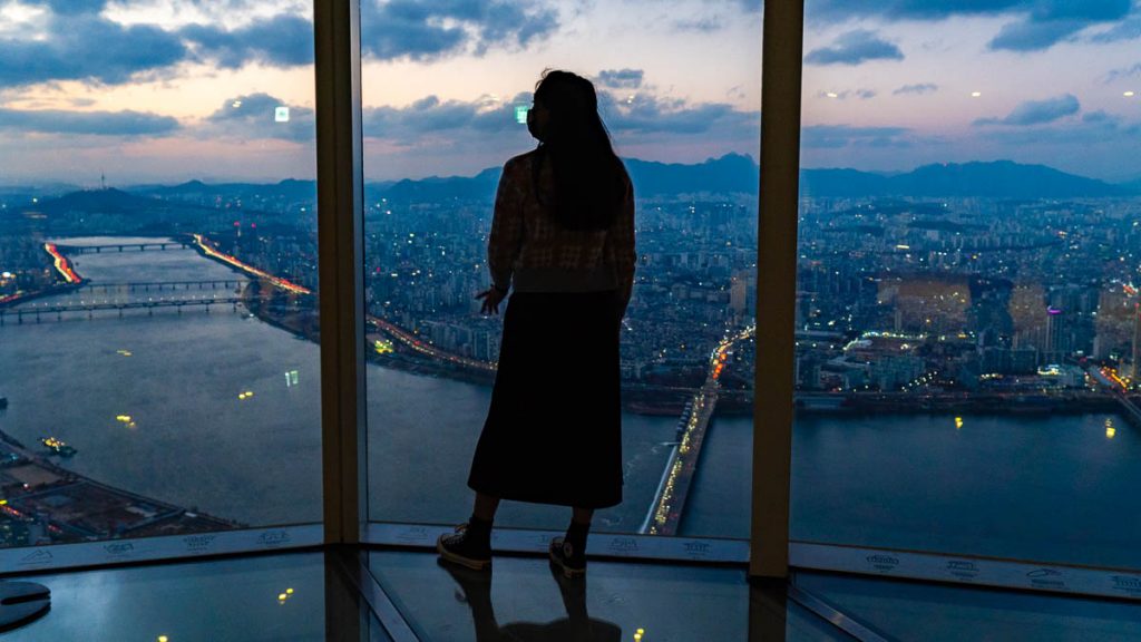 Girl Standing in Lotte World Tower Seoul Sky Singapore South Korea VTL Itinerary