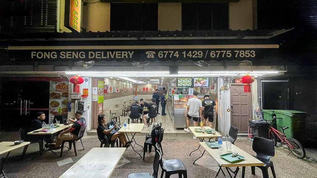 People sitting in a stall - Supper Spot Singapore