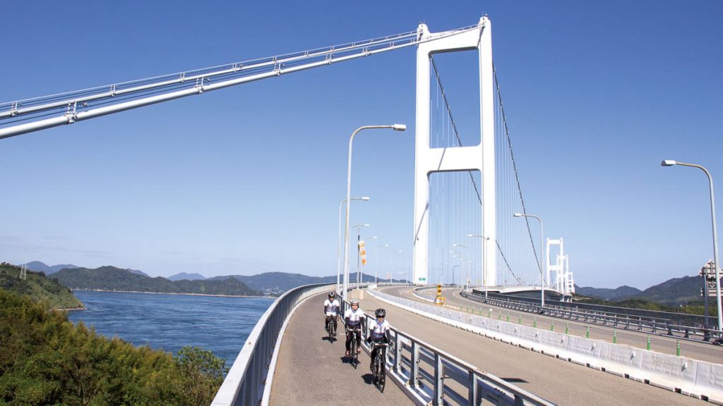 People Cycling on Bridge at Shimanami Kaido - Japan Outdoor Adventures