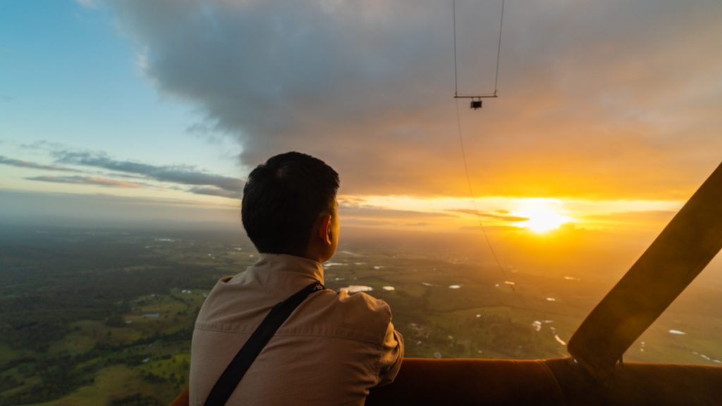 Person Looking at Sunrise on Hot Air Balloon - Queensland Adventure