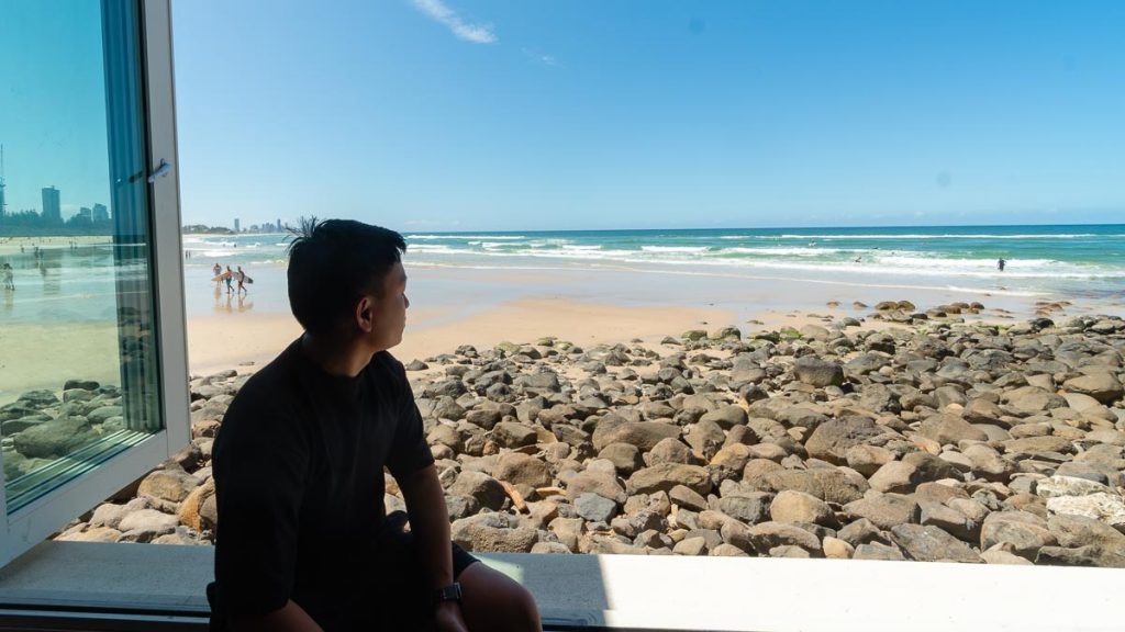 Man Looking Out at Burleigh Beach - Things to do in Gold Coast