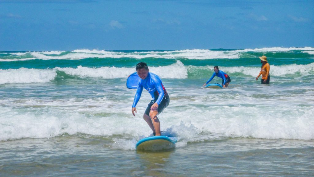 Man on Surf Board - Queensland Travel Guide