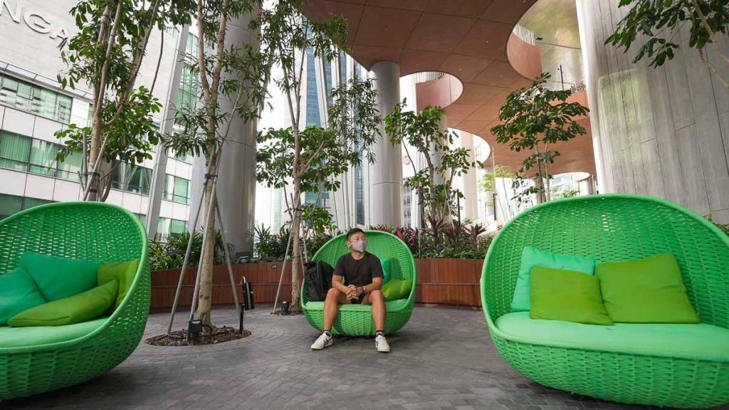 Boy sitting at Capita Spring - Singapore garden 