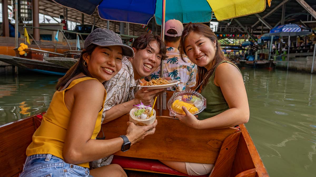 Damnoen Floating Market Tourists with Food - Bangkok Itinerary