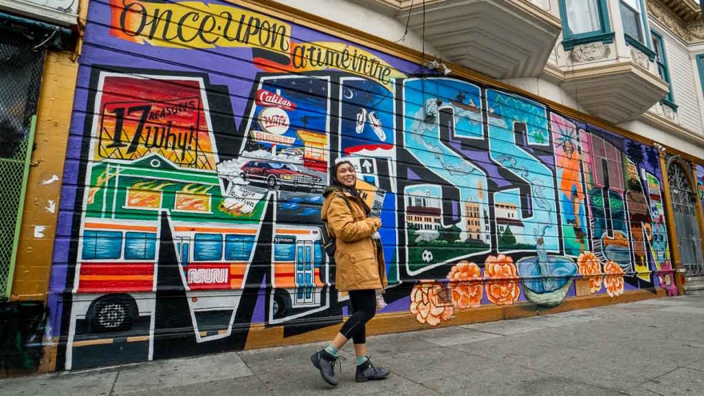 Girl posing with mural at Mission District - SF Itinerary