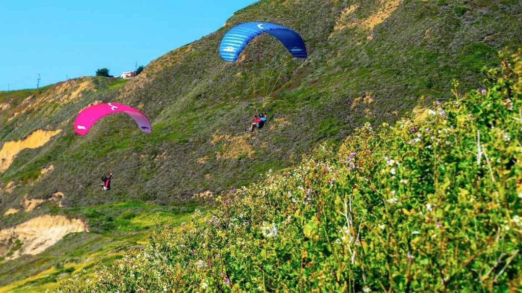 Man Paragliding down Mussel Rock Park- SF Itinerary