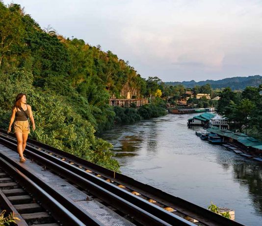 Central Thailand Guide for Explorers — 11 Things to Do in Nakhon Pathom, Ratchaburi, Kanchanaburi Kanchanaburi Death Railway Visitor Walking Along Tham Kra Sae Bridge - Thailand Road Trip
