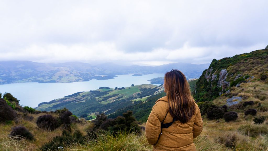 Girl looking at scenery in Akaroa - New Zealand South Island Itinerary