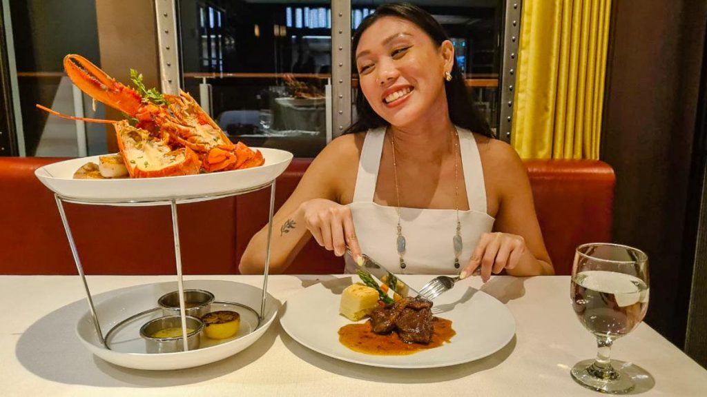 Girl Eating Seafood and Beef - Singapore Cruise