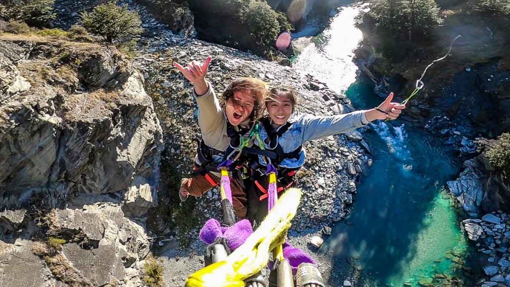 Friends swinging across canyon in Queenstown - New Zealand South Island Itinerary