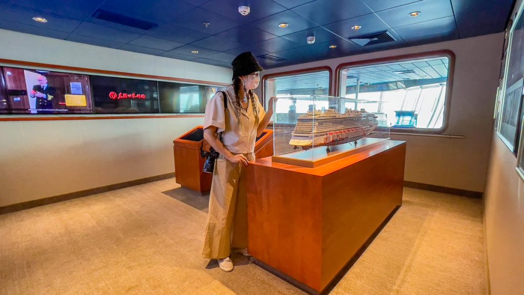 Girl Looking at Ship Replica in Captain's Bridge Viewing Room - Singapore Cruise