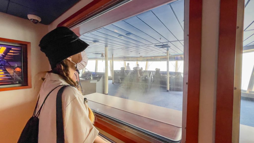 Girl Looking at Captain's Bridge from Viewing Room - Singapore Cruise