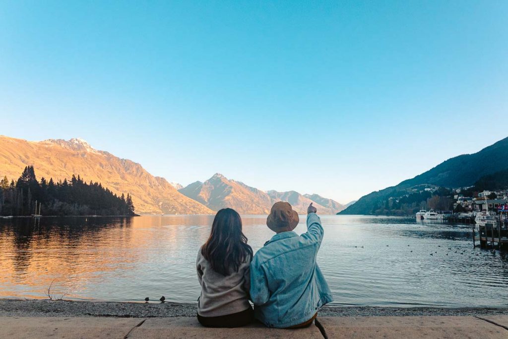 Friends sitting at Lake Wakatipu - New Zealand South Island Itinerary