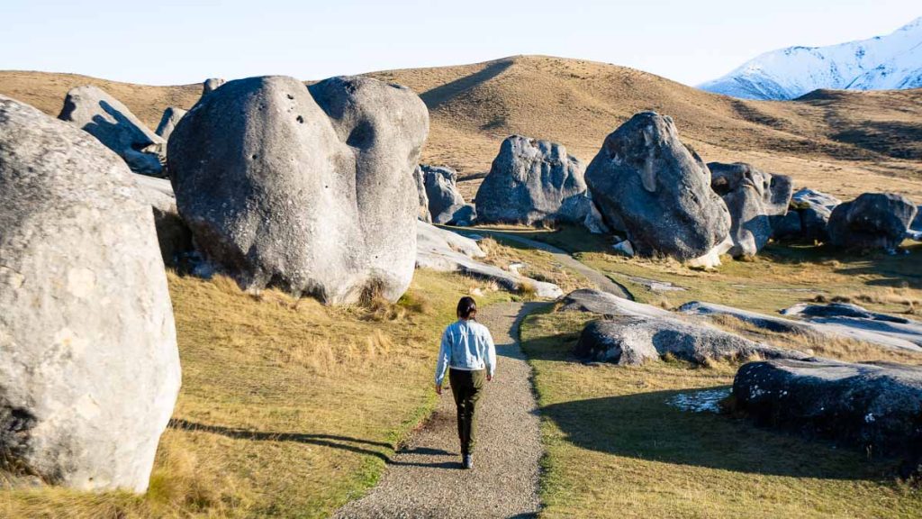 Girl walking along limestone rock s in Kura Tawhiti Arthur's Pass - New Zealand South Island Itinerary