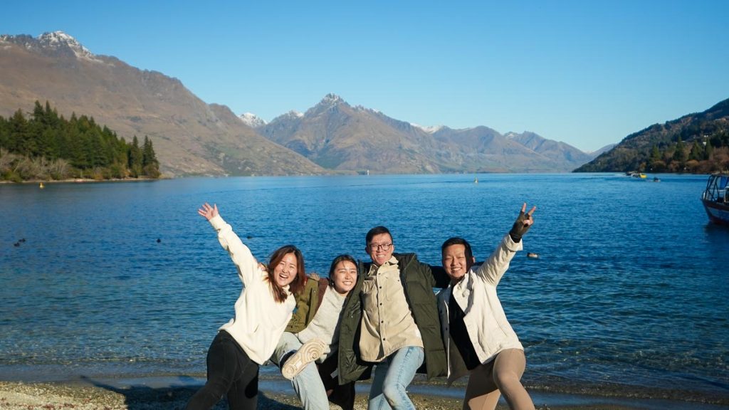 Friends posing at Lake Wakatipu - Things to do in Queenstown New Zealand