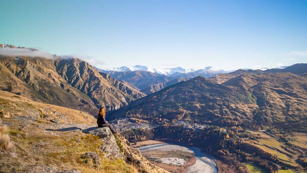 Girl sitting at the top of Queenstown Hill - Things to do in Queenstown New Zealand