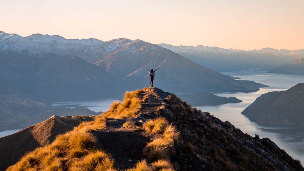 Wanaka Roys Peak Summit Viewpoint During Sunset - New Zealand South Island Guide Bucket List Road Trip