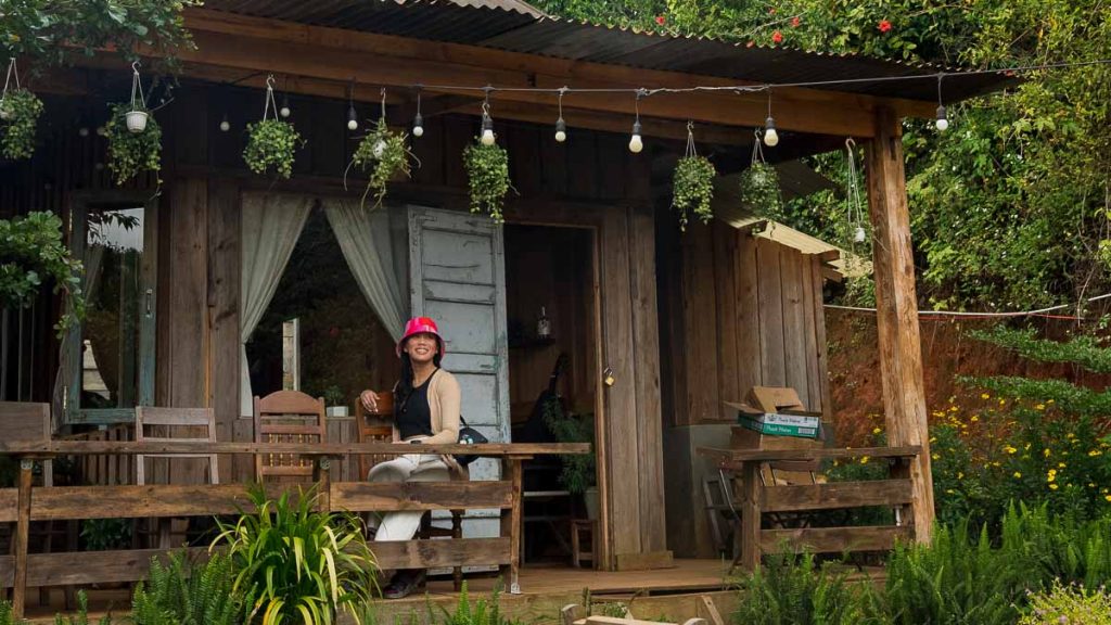 Girl sitting at Cabin in the Woods Cafe Da Lat - Southern Vietnam Food Guide