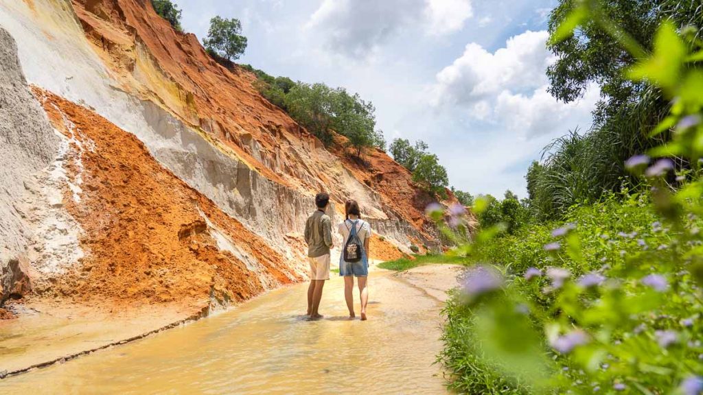 Boy and Girl Walking Along Fairy Stream - Southern Vietnam Itinerary