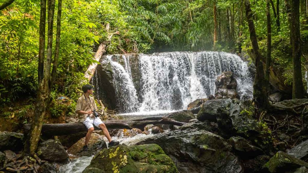 Man Sitting at Suoi Tranh Waterfall - Phu Quoc Itinerary