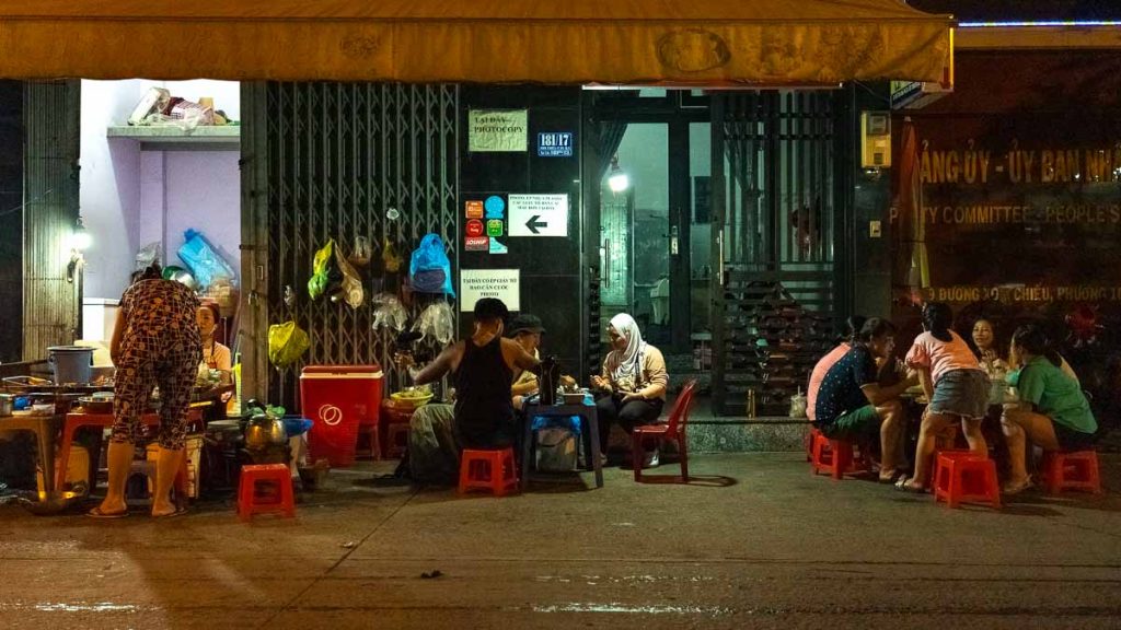 People sitting in small chairs at 200 Market - ho chi minh nightlife