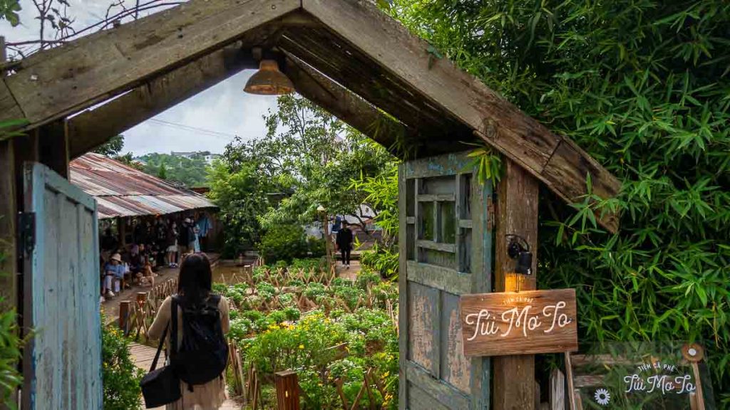 Girl entering the entrance to Cafe Tui Mo To Da Lat