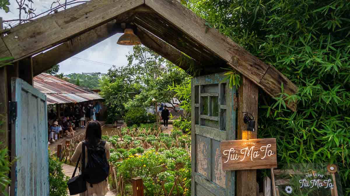 Girl entering the entrance to Cafe Tui Mo To Da Lat - Things to do in Southern Vietnam