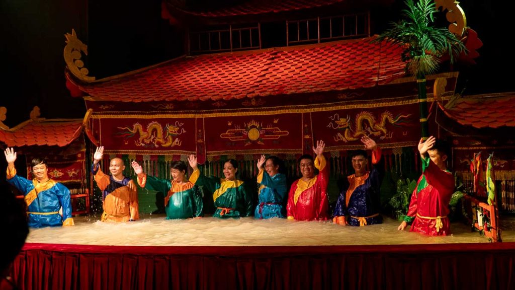 8 puppetiers taking a curtain call during the Golden Water Puppet Show