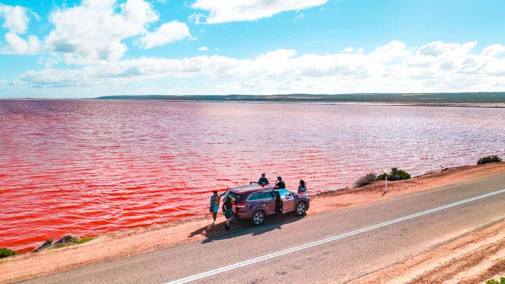 Drone Shot of Car by Pink Lake Hutt Lagoon - Road trips in Australia