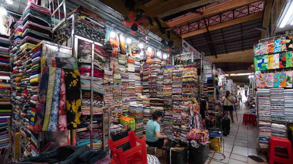 Many rows of fabric stacked up at Ben Thanh Market - Things to do in Vietnam
