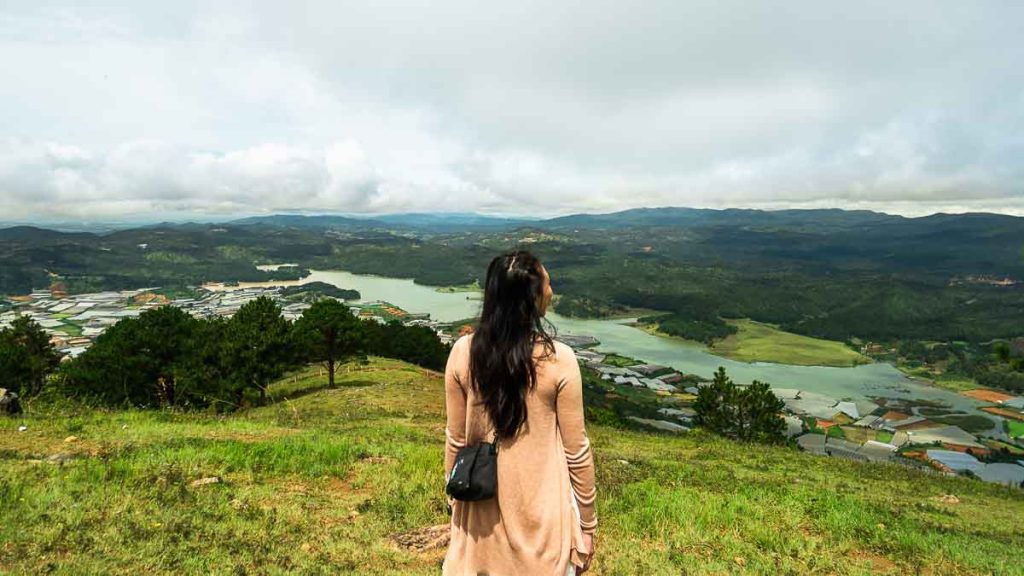 Girl looking at valley on top of Lang Biang mountain peak - Things to do in Southern Vietnam