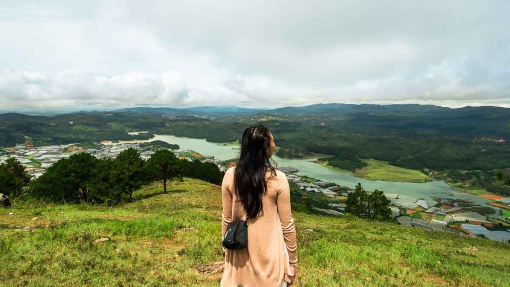 Girl looking at valley on top of Lang Biang mountain peak - Accommodation