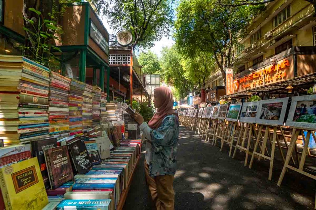 Girl reading book at Ho Chi Minh book street - Things to do in Vietnam